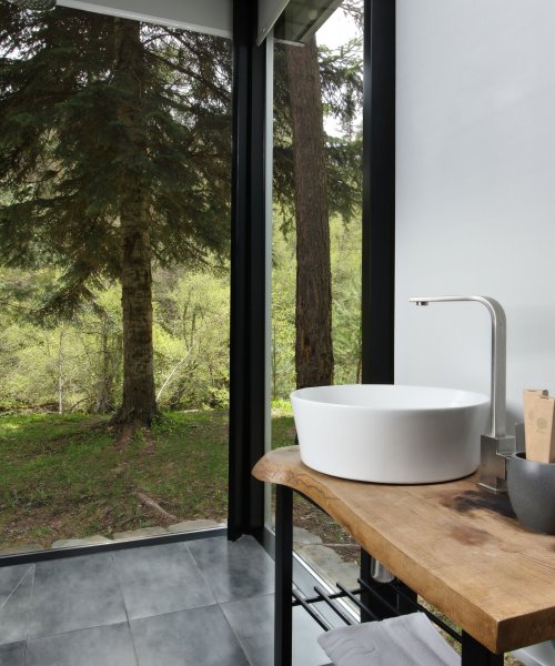 Mirrored house with panoramic windows and river view